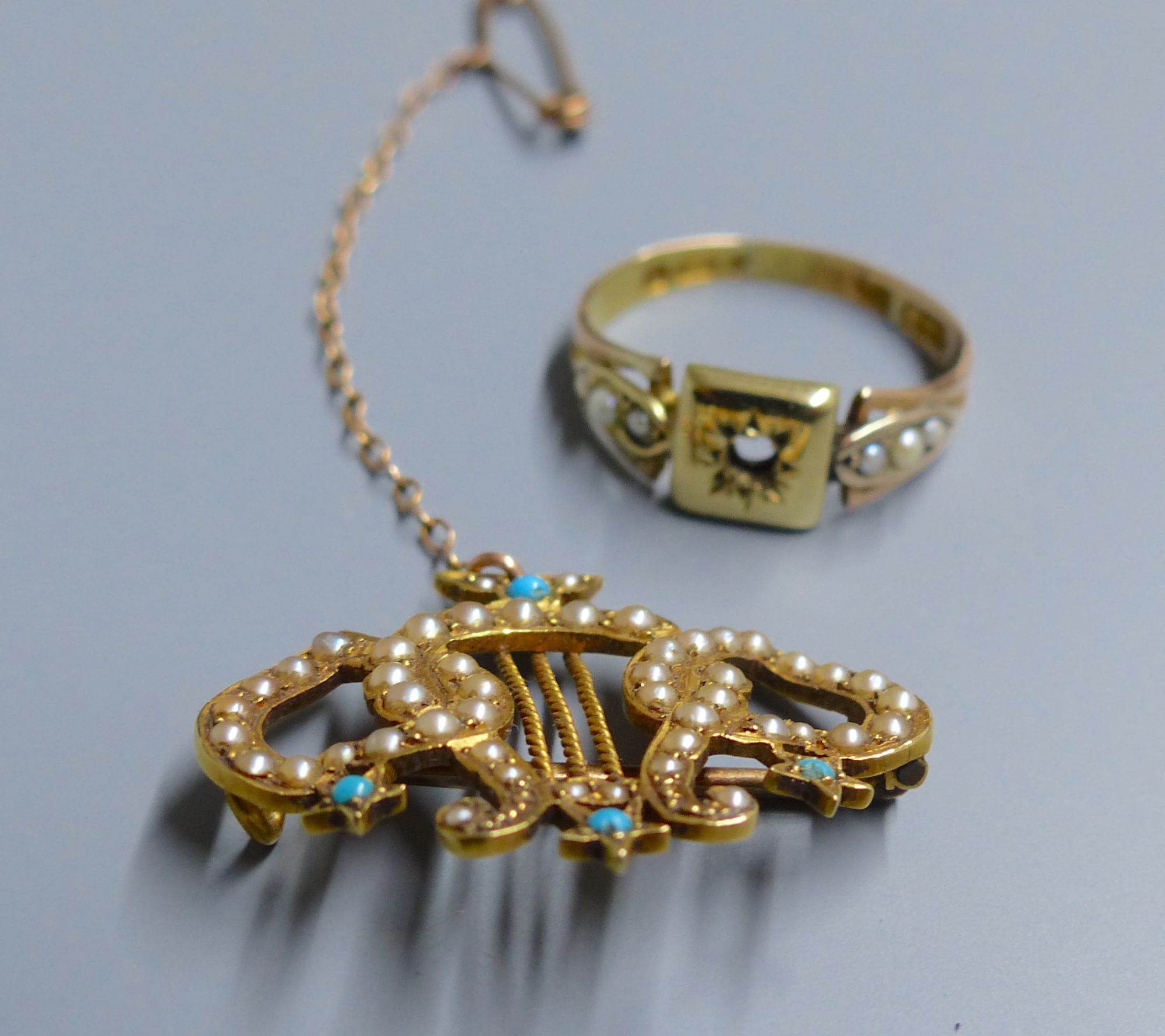 An Edwardian 18ct, turquoise and seed pearl set twin hearts with lyre brooch, 28mm, gross 4.2 grams & a ring.